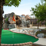 Aqua Golf Santa fe Course view with waterfall behind it