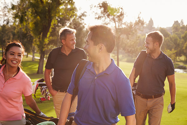 Diverse group of adults golfing